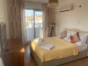 a bedroom with a bed with two towels on it at Deniz Kızı Otel Çeşme in Çeşme