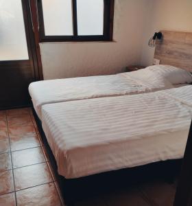 a bedroom with two beds and a window at The Olive Mill in La Murada