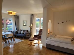 a bedroom with a bed and a living room at BERG-LOVE in Garmisch-Partenkirchen