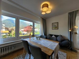 a living room with a table and a large window at BERG-LOVE in Garmisch-Partenkirchen
