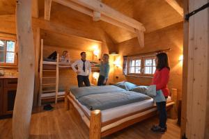 a group of people standing in a bedroom with a bunk bed at Natur-Resort Tripsdrill in Cleebronn
