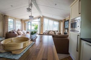 a living room with a couch and a table at Beautiful 6 Berth Lodge At Cherry Tree Holiday Park Ref 70002tg in Great Yarmouth