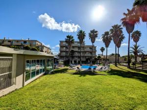 a view of a resort with palm trees at VilaBplaza by JohnVillas in Alvor