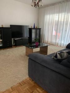 a living room with a couch and a table at Apartment Chie in Izola