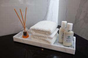 a tray with towels and other products on a table at Elements Hotel & Shops Curaçao in Willemstad