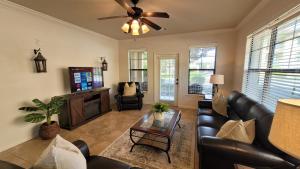 a living room with a couch and a tv at Ground floor condo, no carpet, close to community pools, fitness room, 9 miles to Disney World in Davenport