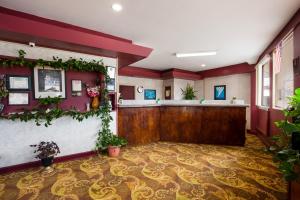 a lobby with a waiting area with plants at Knights Inn Fayetteville - Fort Bragg in Fayetteville