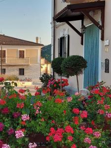 a garden of flowers in front of a building at CASA PIERA in Acciano