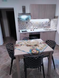 a kitchen with a table with chairs and a sink at LA TERRAZZA in Ioppolo Giancaxio