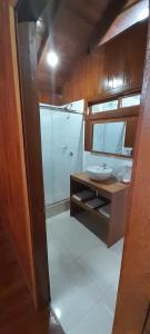 a bathroom with a sink and a shower at Chontaqui Eco-Lodge in Oxapampa