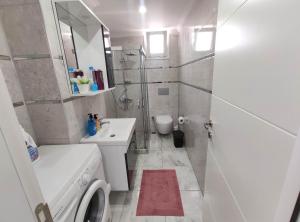 a white bathroom with a sink and a shower at Denizolgun Homes Gazibulvarı in Dalaman