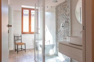 a bathroom with a glass shower and a sink at Mahthildis Agriturismo B&B in Vermezzo