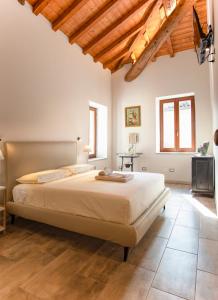 a bedroom with a large bed in a room with wooden ceilings at Mahthildis Agriturismo B&B in Vermezzo