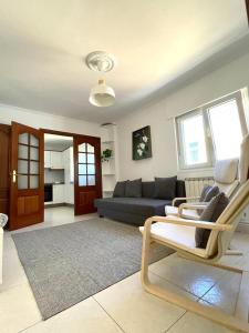 a living room with a couch and a blue couch at Casa Lameiro in Lugo