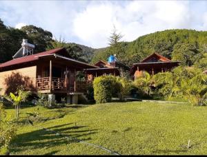 a man standing on the balcony of a house at Chontaqui Eco-Lodge in Oxapampa