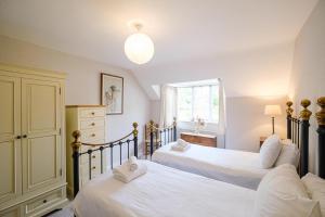 a bedroom with two beds and a window at 9 Whinlands in Thorpeness