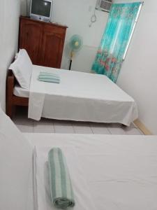 a bedroom with a bed and a tv in a room at Pescador View Extension near the Ocean in Moalboal +24 photos