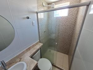a bathroom with a shower and a toilet and a sink at Anequim in Cabedelo