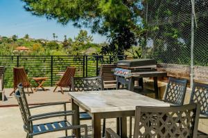 een patio met tafels en stoelen en een grill bij Guest House with Amazing views and Sauna in Monterey Park