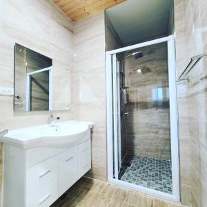 a bathroom with a white sink and a shower at Fay Homestay in Yilan City