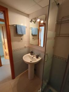 a bathroom with a sink and a shower with a mirror at Morada del Mar in Palomares
