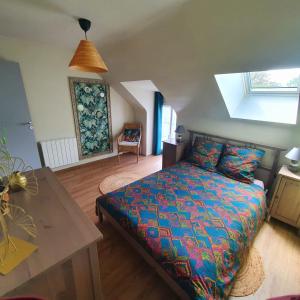 Schlafzimmer mit einem Kingsize-Bett und einem Tisch in der Unterkunft Maison bretonne au cœur d'un petit hameau 
