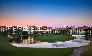 a view of a resort with a pond and buildings at Arizona Grand Resort in Phoenix