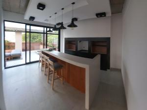 a kitchen with a counter and some chairs in it at Usina AS Salta in Salta