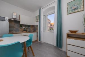 a kitchen with a table and chairs and a window at Harmony Apartments in Split +34 photos