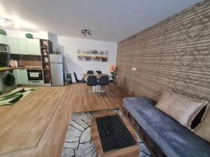 a living room with a couch and a table at ERAS - Топ център Варна in Varna City