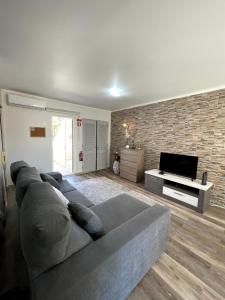 a living room with a couch and a flat screen tv at Marina Plaza in Vilamoura