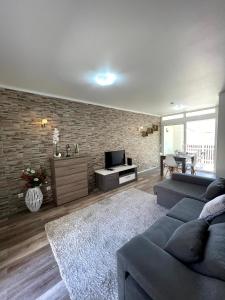 a living room with a couch and a television at Marina Plaza in Vilamoura