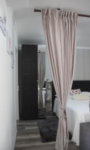 a bedroom with a bed with a curtain at Marina Plaza in Vilamoura