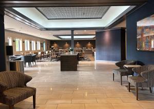 a lobby with a waiting area with chairs and tables at Best Western Premier Rockville Hotel & Suites in Rockville