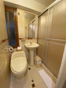 a bathroom with a toilet and a sink and a shower at Inka House Hotel in Machu Picchu +25 photos