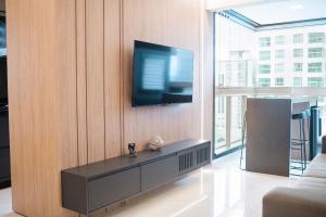 a living room with a tv on a wall at Safira in Meia Praia