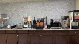 a kitchen counter with a microwave and a coffee maker at Days Inn By Wyndham Lexington-Columbia in Lexington
