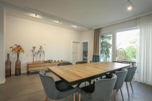 a dining room with a wooden table and chairs at Kuća sa bazenom do 10 osoba Freedom Place in Jagodina