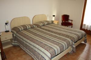 Postel nebo postele na pokoji v ubytování Hotel Bodoni
