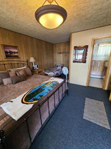 A bed or beds in a room at Tolsona Lake Lodge