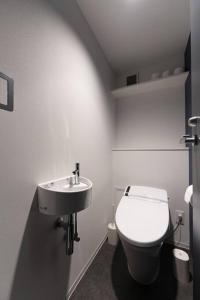 a bathroom with a white toilet and a sink at Corent代田橋 in Tokyo