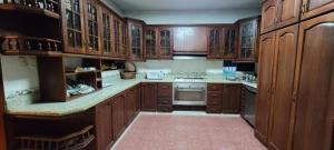 a kitchen with wooden cabinets and a stove top oven at Torres Apart Studio in Santo Domingo