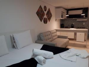 een woonkamer met een bed en een bank bij Laguna Beach Porto de Galinhas in Camela