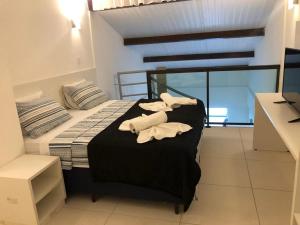 een slaapkamer met een bed met twee handdoeken erop bij Laguna Beach Porto de Galinhas in Camela +57 foto's