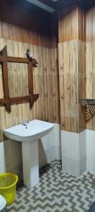 a bathroom with a white sink and wooden walls at Barn Hills in Ella