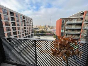 a view of a city from a balcony with buildings at East London's hidden gem - relax after sightseeing in a huge canal view balcony in London