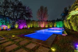 a garden lit up at night with a swimming pool at Woodland Hills Paradise Resort Style Home in Los Angeles
