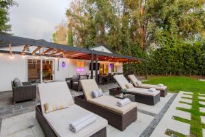 a patio with a bunch of chairs and tables at Woodland Hills Paradise Resort Style Home in Los Angeles