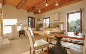 a kitchen with a wooden table and a fireplace at Awesome Home In Maratea With 3 Bedrooms And Wifi in Maratea