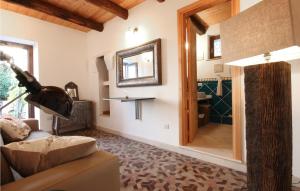 a living room with a couch and a mirror at Awesome Home In Maratea With 3 Bedrooms And Wifi in Maratea
